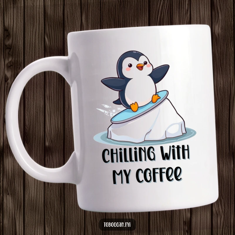 Funny playful penguin surfing on a small iceberg with a big smile on a mug, perfect for ocean lovers and bird fans.