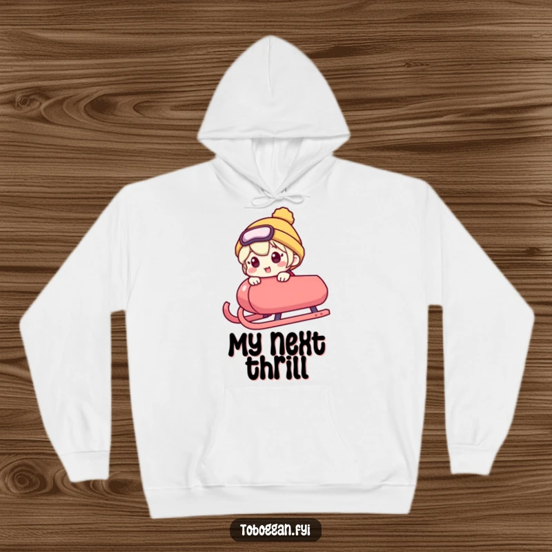 Funny hoodie shows a character peeking over a sled's edge with an excited expression, embodying humorous anticipation for winter activities.
