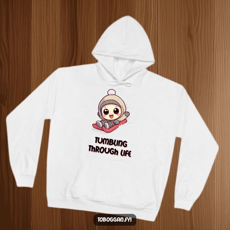 Funny character with wide, happy eyes tumbling down a sledding slope on a cozy hoodie.