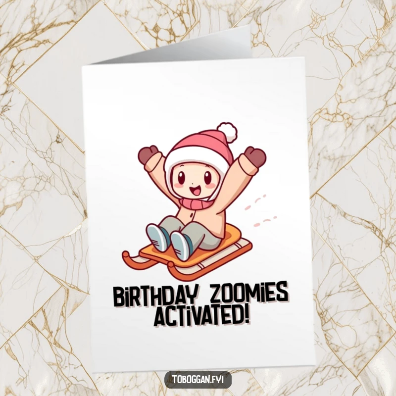 Funny free printable birthday card showing a character joyfully zooming downhill on a sled with arms raised high.