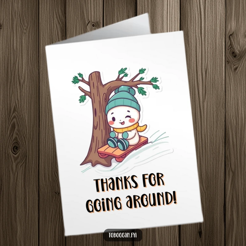 Funny Free Printable Thank You Card: A playful character with a cheeky grin steers a toboggan around a tree, expressing thanks humorously.