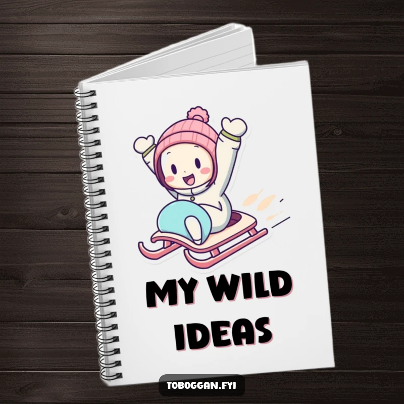 Funny Downhill Sledding Notebook with a character zooming downhill on a sled with arms in the air, ideal for noting adventures.